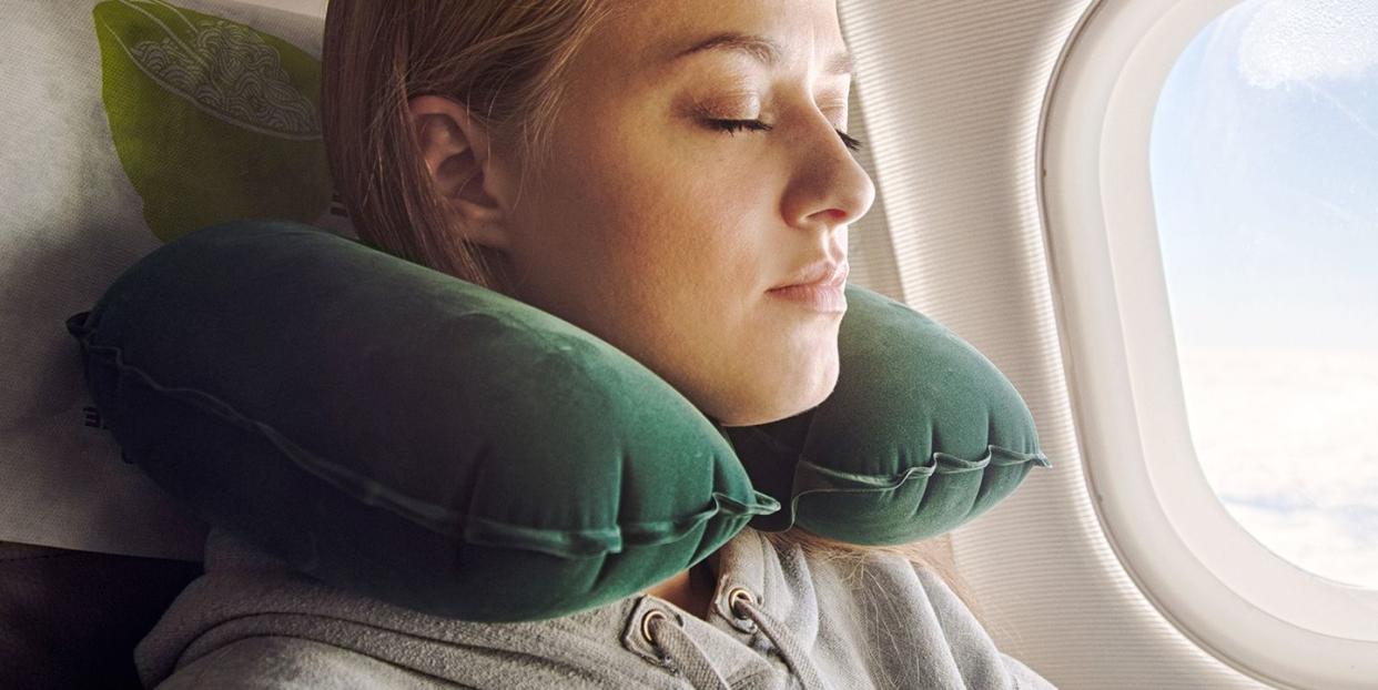 woman using green travel pillow