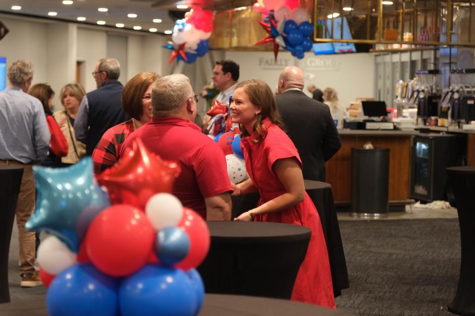 Caroline Fairly speaks to an attendee following her speech Tuesday night at Hodgetown in Amarillo.