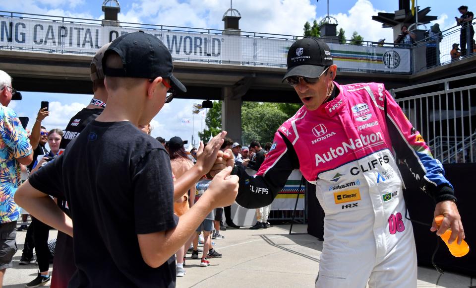 Meyer Shank Racing driver Hélio Castroneves (06) greets fans Saturday, Aug. 12, 2023, ahead of the Gallagher Grand Prix at Indianapolis Motor Speedway.