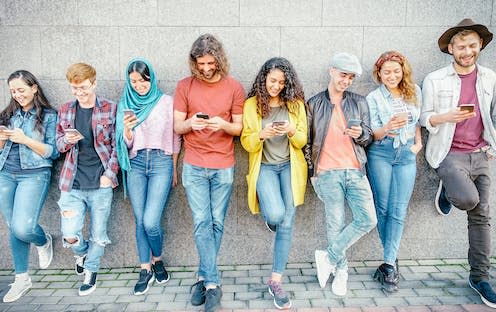 <span class="caption">Gen Z smartphone addiction can support compulsive buying habits. </span> <span class="attribution"><a class="link " href="https://www.shutterstock.com/image-photo/group-fashion-friends-watching-on-their-1254124996" rel="nofollow noopener" target="_blank" data-ylk="slk:AlessandroBiascioli / Shutterstock;elm:context_link;itc:0;sec:content-canvas">AlessandroBiascioli / Shutterstock</a></span>