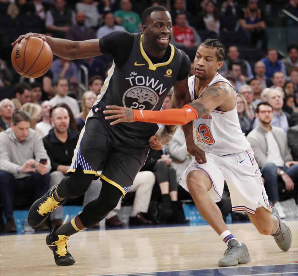 New York Knicks guard Trey Burke (23) defends Golden State Warriors forward Draymond Green (23) during the first half of an NBA basketball game, Monday, Feb. 26, 2018 in New York. (AP Photo/Kathy Willens)