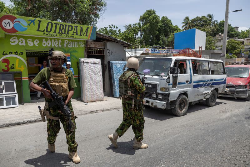 Kenyan police and Haitian National police SWAT units patrol streets in armoured vehicles, in Port-au-Prince