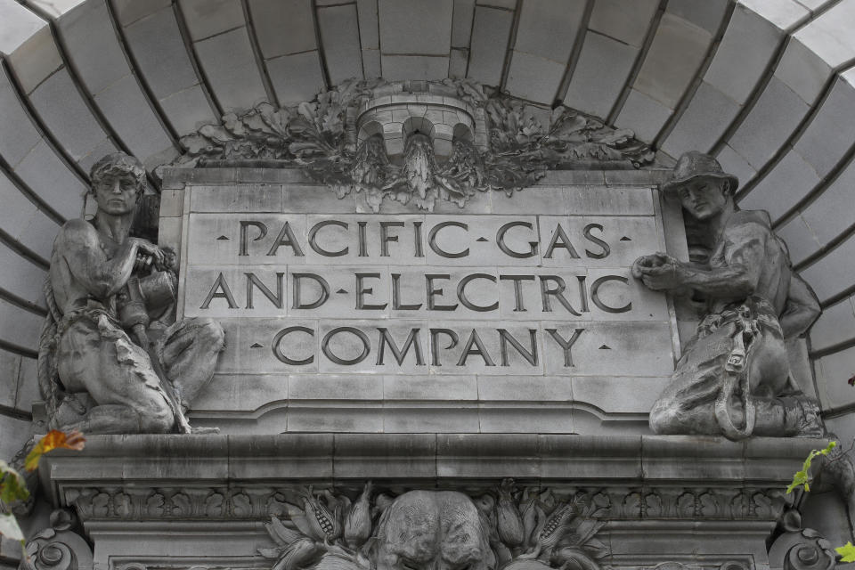 FILE - In this April 16, 2020, file photo, a Pacific Gas & Electric sign is displayed on the exterior of a PG&E building in San Francisco. Pacific Gas & Electric will cut power to over 1 million people on Sunday to prevent the chance of sparking wildfires as extreme fire weather returns to the region, the utility announced Friday, Oct. 23, 2020. (AP Photo/Jeff Chiu, File)