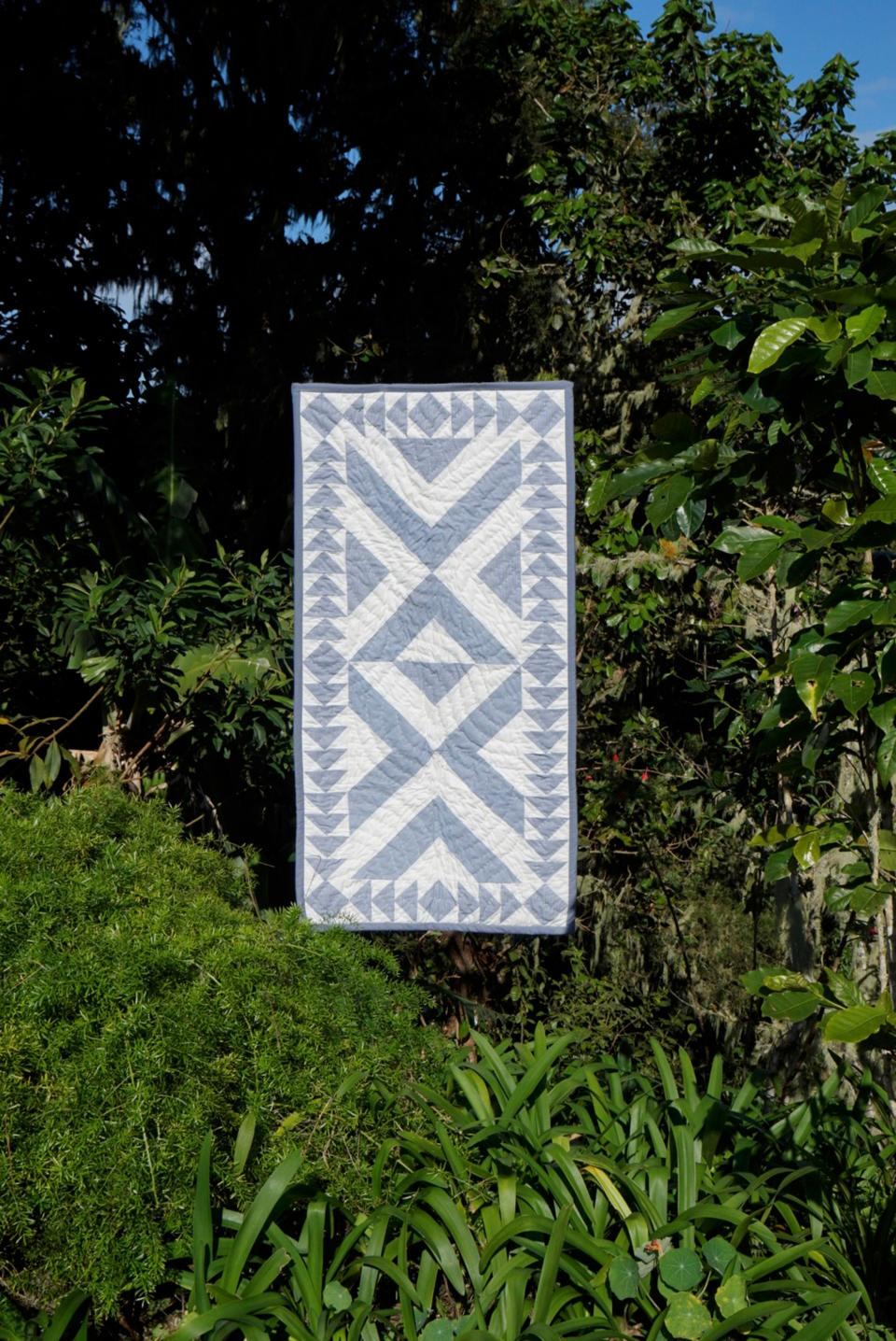 Ogden and photographer Alfredo Piola climbed to top of Blue Mountain Peak, Jamaica’s highest mountain, to photograph the quilts and pillows. Pictured here, the Rondo quilt.