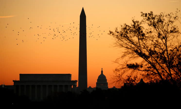 Birds fly over the Lincoln Memorial, the Washington Monument and the U.S. Capitol at sunrise on election day in Washington, November 8, 2016. (Photo: Kevin Lamarque/Reuters)