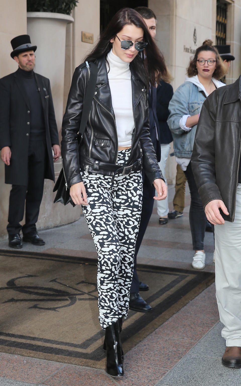 <p>The model opted for a black leather jacket, cool printed pants, and a white turtleneck in the City of Lights.</p>