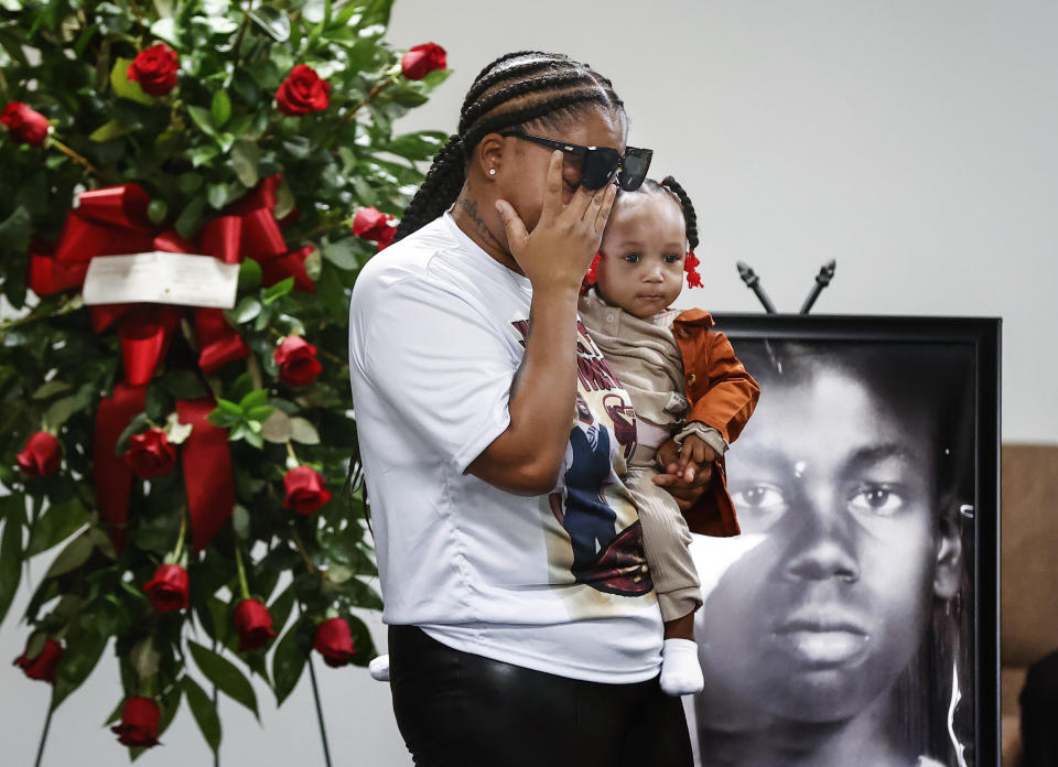 Sierra Rogers, holding her daughter Khloe Rogers, 1, wipes away tears as she speaks during a memorial service for her friend Tyre Nichols, Tuesday, Jan. 17, 2023, in Memphis, Tenn. Nichols was killed during a traffic stop with Memphis Police on Jan. 7. (Mark Weber/Daily Memphian via AP)