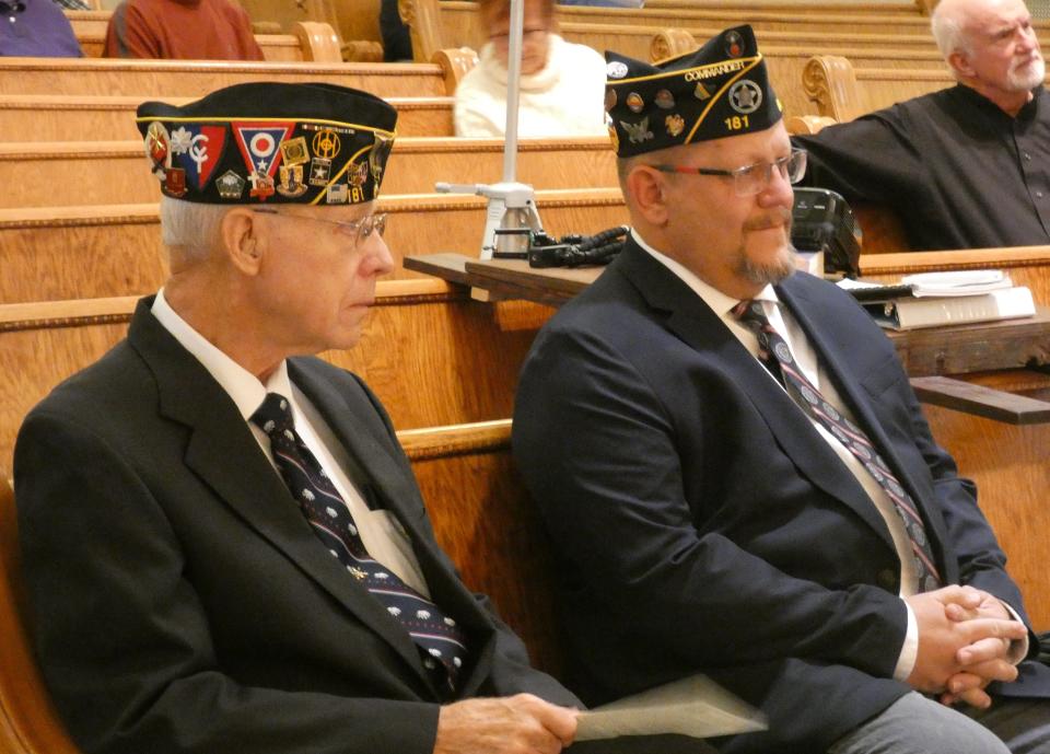 Doug Wilson, left, and Ty Bowers listen to closing remarks during a special Veterans Day ceremony Friday at St. Paul's Lutheran Church. The event included a special tribute to Congressional Medal of Honor winner 1st Lt. Harry L. Martin.