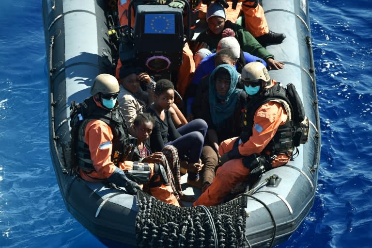 Refugees are transported to a German warship -- that is helping to capture migrant-smugglers trying to cross the Mediteranean Sea, on September 26, 2015