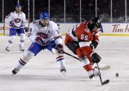 <p>Tomas Plekanec and Erik Karlsson battle for the puck during the first period of the NHL 100 Classic on Saturday. </p>