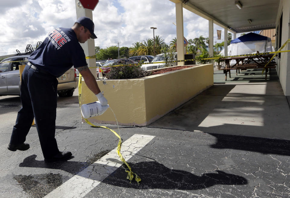 <p>A Fort Myers fire fighter pours bleach over blood stains on the pavement at the scene of a deadly shooting outside the Club Blu nightclub in Fort Myers, Fla., Monday, July 25, 2016. (AP Photo/Lynne Sladky)</p>