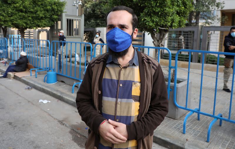 Syrian refugee, Khaled Alyousef, stands in front of UNHCR offices in Beirut