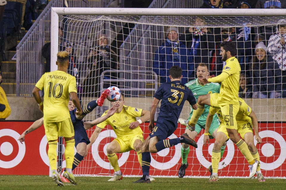 Philadelphia Union's Deniel Gazdag, second from left, kicks the ball past Nashville SC's Joe Willis, third from right, for a goal during the first half of an MLS playoff soccer match, Sunday, Nov. 28, 2021, in Chester, Pa. (AP Photo/Chris Szagola)
