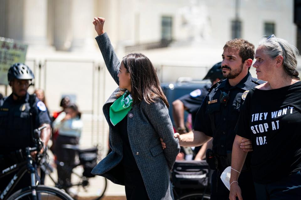 Representative Alexandria Ocasio-Cortez, a Democrat from New York, is arrested outside the US Supreme Court during a protest of the court overturning Roe v. Wade in Washington, D.C., US, on Tuesday, July 19, 2022. The high court's reversal of the 1973 landmark decision protecting the federal right to abortion has sent shock waves through the medical, legal and advocacy communities with the White House signing an executive order intended to preserve access to the procedure. Photographer: Al Drago/Bloomberg via Getty Images