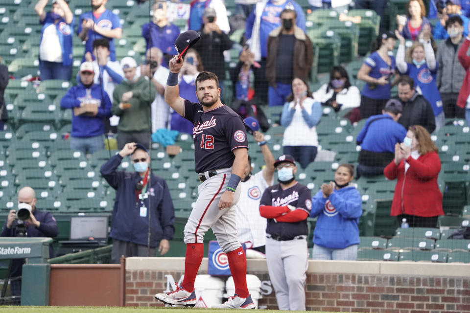 Washington Nationals left fielder Kyle Schwarber (12) tips his cap as the former Cub is honored before a baseball game against the Chicago Cubs, Monday, May, 17, 2021, in Chicago. (AP Photo/David Banks)