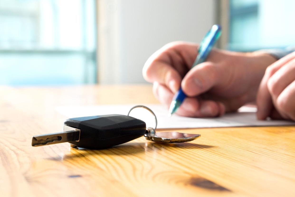 Man signing car paperwork