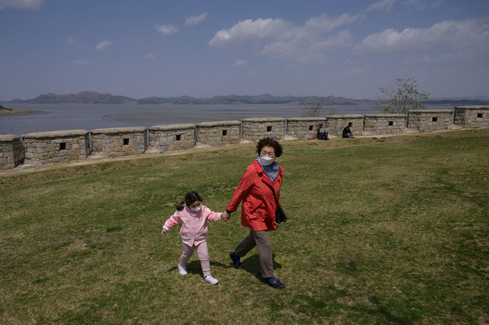 Visitors walk before a viewpoint overlooking the North Korean shoreline (C) and the Demilitarized Zone (DMZ) separating North and South Korea, on the South Korean island of Ganghwa on April 23, 2020. - The United States will keep seeking North Korea's denuclearization no matter who is in charge in Pyongyang, Secretary of State Mike Pompeo said, amid speculation about leader Kim Jong Un's health. (Photo by Ed JONES / AFP) (Photo by ED JONES/AFP via Getty Images)