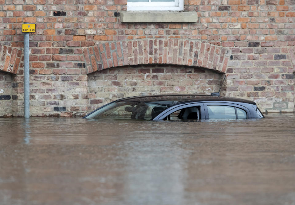 A car is submerged in flood water in York after the River Ouse bursts its banks at the weekend. Source: PA