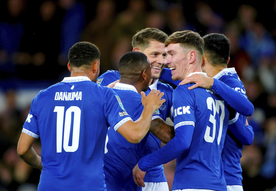 Everton's James Tarkowski, center, celebrates scoring with teammates during the English League Cup fourth round soccer match between Everton and Burnley at Goodison Park, Liverpool, England, Wednesday Nov. 1, 2023. (Peter Byrne/PA via AP)
