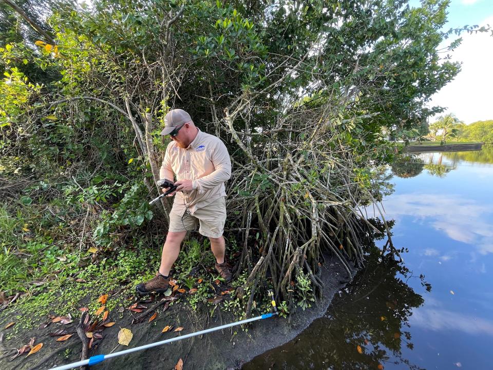 Codty Pierce records conditions when sampling for fecal bacteria, which he and a corps of Calusa Waterkeeper volunteers do monthly,
