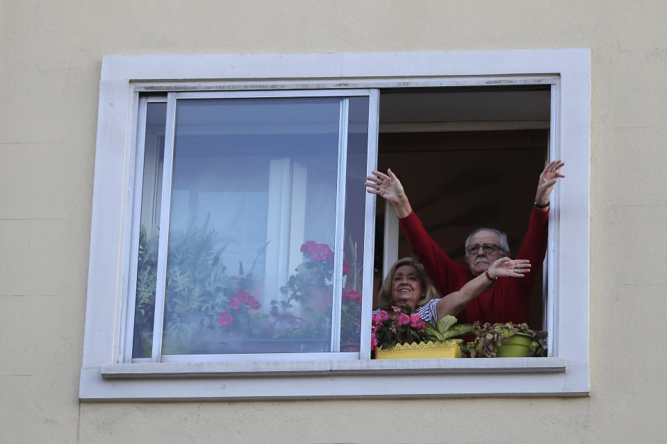 People applaud from their houses in support of the medical staff that are working on the COVID-19 virus outbreak at the Gregorio Maranon hospital in Madrid, Spain, Wednesday, April 1, 2020. The new coronavirus causes mild or moderate symptoms for most people, but for some, especially older adults and people with existing health problems, it can cause more severe illness or death. (AP Photo/Manu Fernandez)