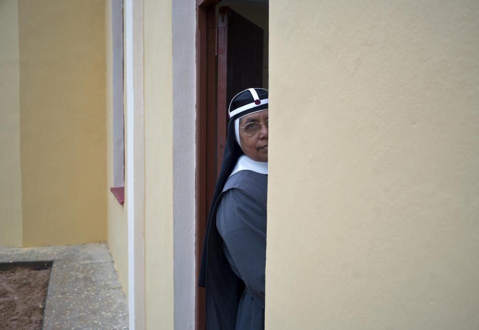 A nun waits for the start of a consecration Mass of the Sagrado Corazon de Jesus Catholic church or Sacred Heart, in Sandino, Cuba, Saturday, Jan. 26, 2019. Of the three Catholic churches the Cuban government has authorized, it's the first one in 60 years to be completed. It was finished with the help of Tampa's St. Lawrence Catholic Church in Florida. (AP Photo/Ramon Espinosa)