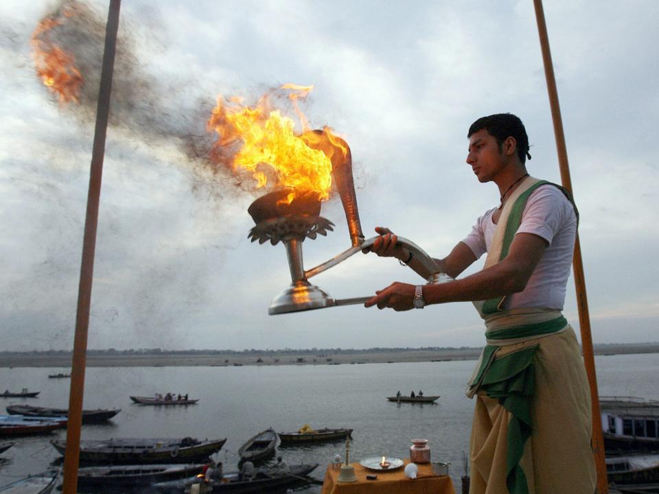 A Hindu priest offers morning prayers in Varanasi in 2006.