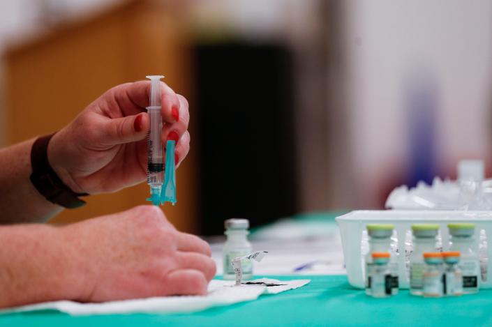 A nurse prepares a syringe of COVID-19 vaccine during a mass vaccination clinic for children ages 5-11 and any others who wanted to get vaccinated at Williams Elementary School in Springfield, Missouri, on Nov. 20.