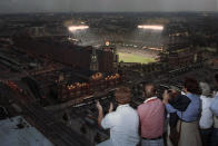 FILE - Baseball fans on a nearby rooftop applaud as they watch the Baltimore Orioles play the California Angels at Camden Yards in Baltimore, Md., Wednesday, Sept. 6, 1995. Orioles' Cal Ripken broke Lou Gehrig's record of 2,130 consecutive games. For the first time in 53 years, Baltimore is hosting the AFC championship game this weekend. It's probably the biggest sporting event here since Ripken broke Gehrig's record.(AP Photo/Gary Sussman, File)