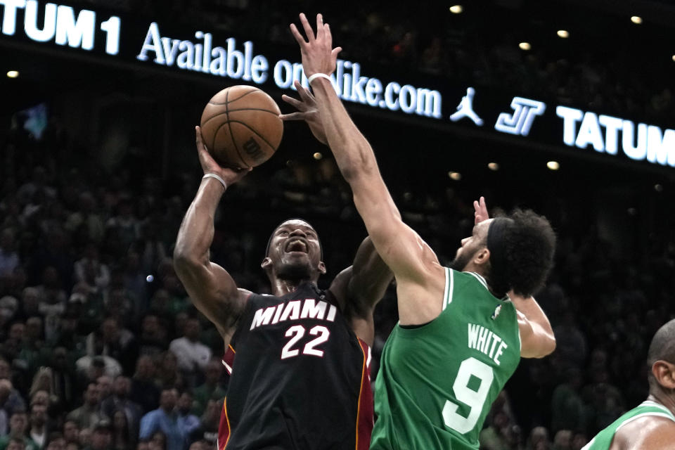 Miami Heat forward Jimmy Butler, left, shoots as Boston Celtics guard Derrick White defends during the first half in Game 7 of the NBA basketball Eastern Conference finals Monday, May 29, 2023, in Boston. (AP Photo/Charles Krupa )