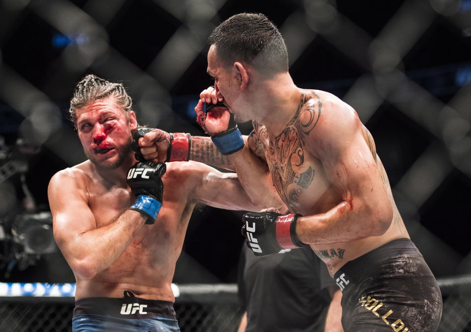 Max Holloway, right, fights Brian Ortega during the featherweight championship mixed martial arts bout at UFC 231 in Toronto on Saturday, Dec. 8, 2018. (Nathan Denette/The Canadian Press via AP)