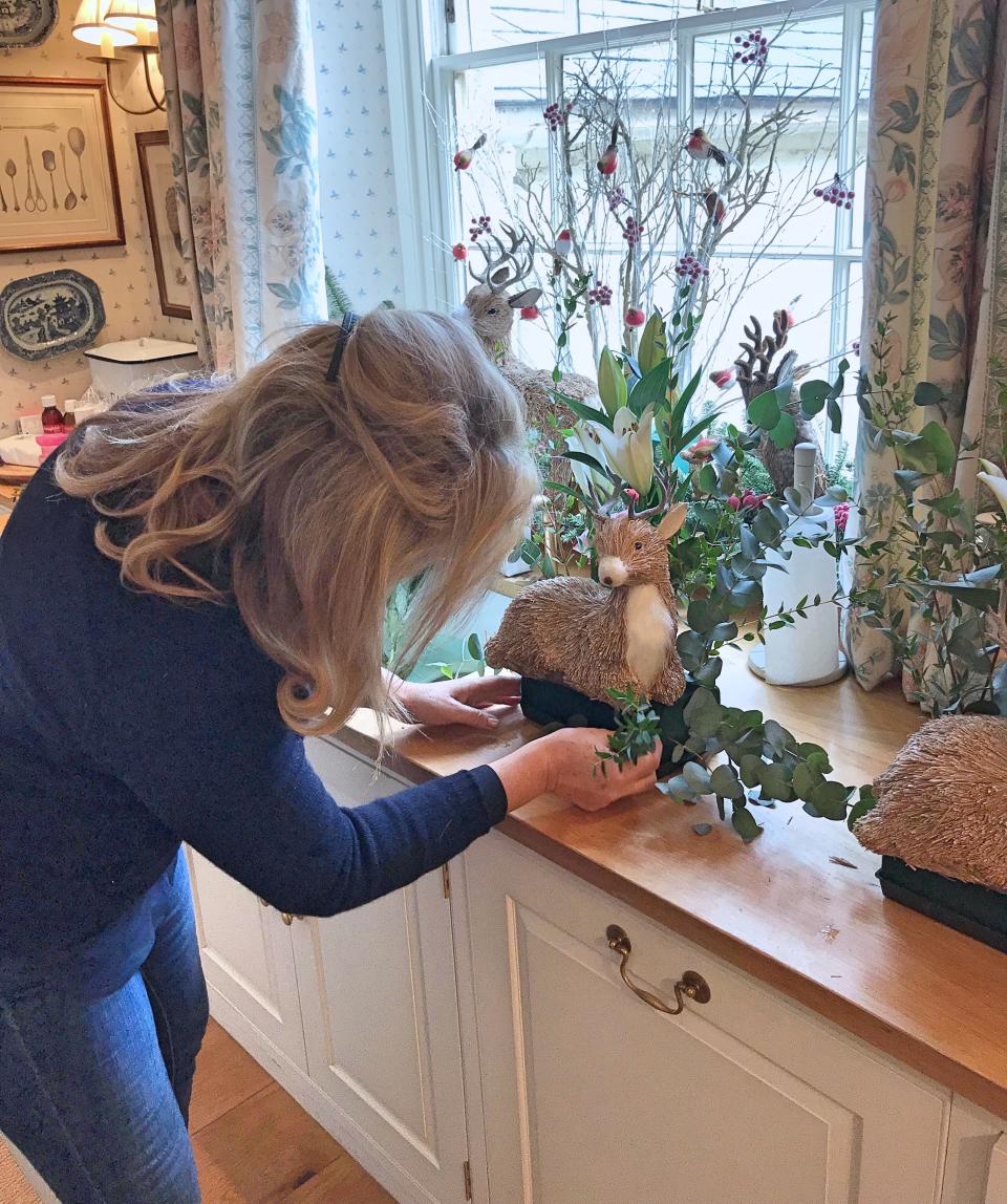 My mother is a genius when it comes to the tricky part of assembling all these woodland creatures into an oasis. Here she is putting the finishing touches to this sweet little deer.