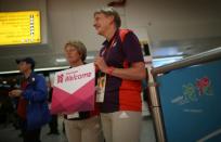 LONDON, ENGLAND - JULY 16: Olympic volunteers wait to greet arriving teams at Heathrow Airport on July 16, 2012 in London, England. Athletes, coaches and Olympic officials are beginning to arrive in London ahead of the Olympics.