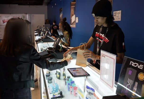 PHOTO: Customers buy cannabis products at Smacked! Village. (ABC News)