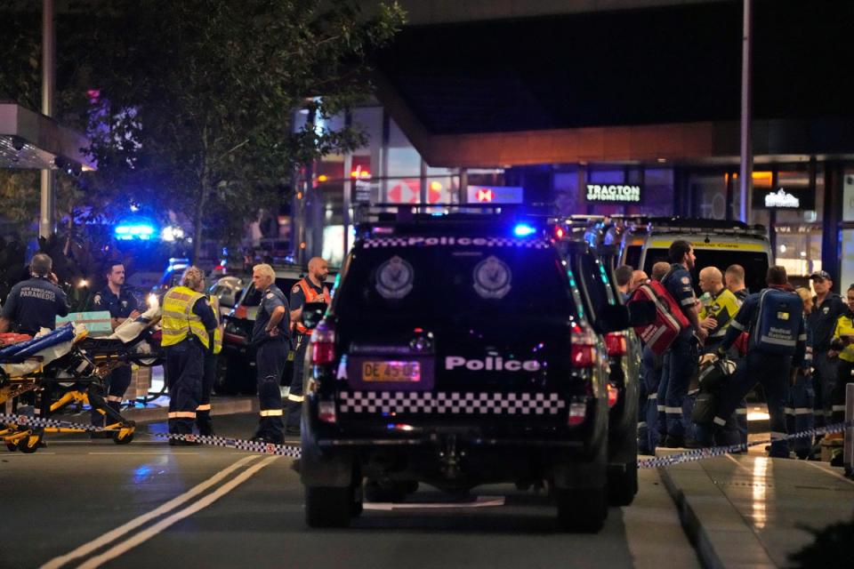 Emergency officers outside Westfield Shopping Centre in Sydney on Saturday (AP)