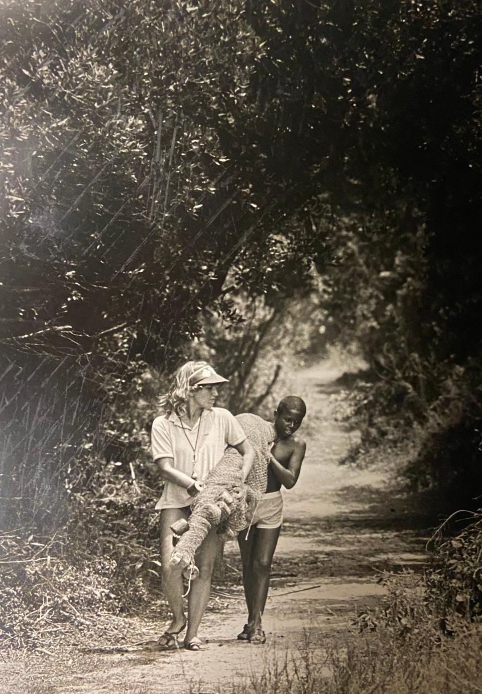 In 1983 Jan Cook, a counselor at a 4-H camp on Jekyll Island, and 12-year-old Juan Webb from Macon, Ga., return from the beach carrying a seine net. They were part of a beachcombing camp on the island.