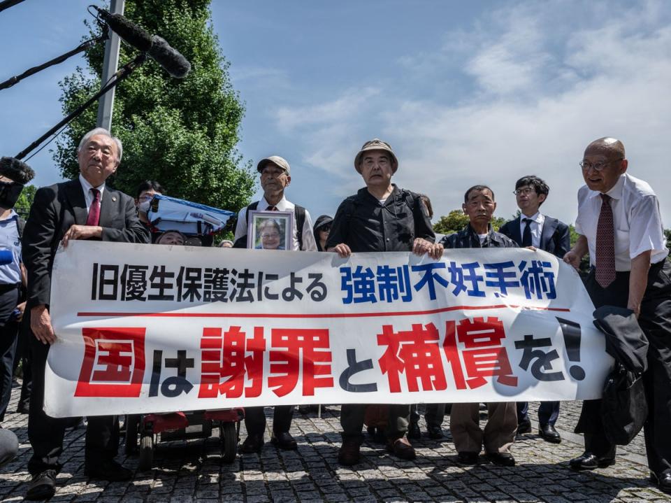 Supporters and lawyers of victims of forced sterilisation march toward Japan’s supreme court in Tokyo on 3 July 2024 (AFP via Getty)