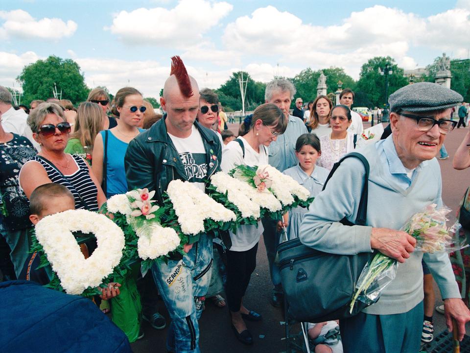 People leave floral tributes outside Buckingham Palace in London, after the death of Diana, Princess of Wales, on September 2, 1997.