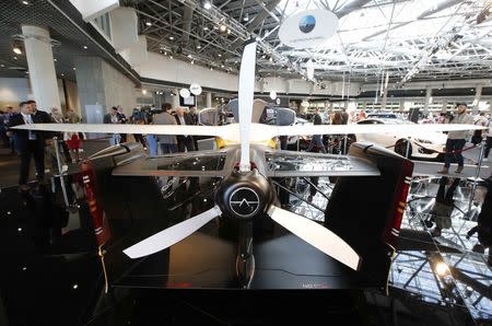 People look at the AeroMobil flying car during its unveiling at the Top Marques Monaco supercar show in Monaco April 20, 2017. REUTERS/Jean-Paul Pelissier