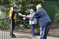 People arrive at a walk in coronavirus testing station set up in Spinney Hill park in Leicester, England, Tuesday June 30, 2020. The British government has reimposed lockdown restrictions in the English city of Leicester after a spike in coronavirus infections, including the closure of shops that don't sell essential goods and schools. (AP Photo/Rui Vieira)