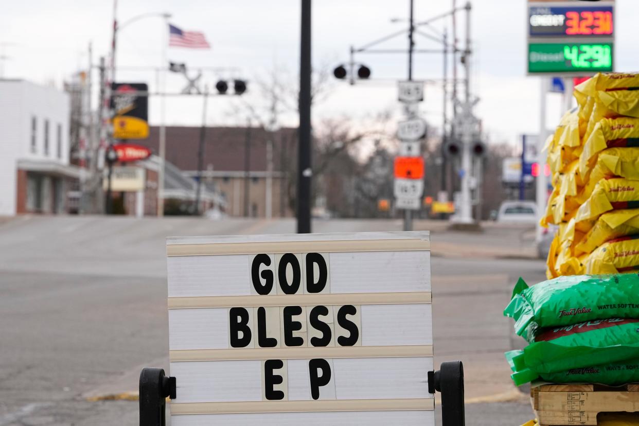 A "God bless EP" sign sits beside the railroad tracks in downtown East Palestine in February.