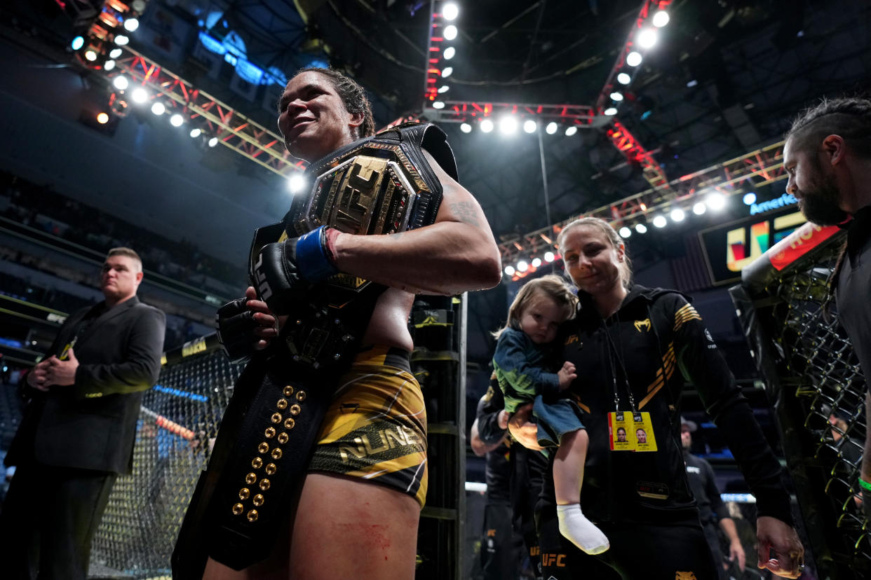 DALLAS, TEXAS - JULY 30: Amanda Nunes of Brazil exits the Octagon with wife Nina Ansaroff and daughter Raegan after defeating Julianna Pena in the UFC bantamweight championship fight during the UFC 277 event at American Airlines Center on July 30, 2022 in Dallas, Texas. (Photo by Chris Unger/Zuffa LLC)