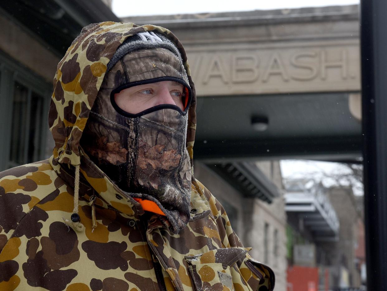 Josh Carroll stands outside the Wabash Bus Station at Tenth and Ash streets last February, waiting for the station to open so he can get warm.