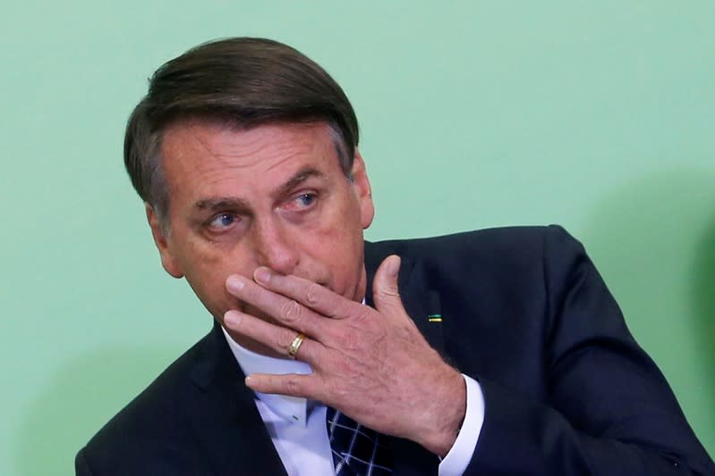 Brazil's President Jair Bolsonaro reacts during a ceremony at the Planalto Palace in Brasilia