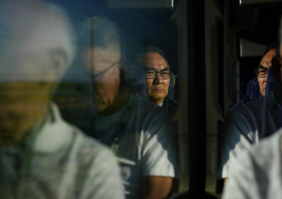 Richard Oba takes a bus to the Minidoka National Historic site with other Minidoka Pilgrimage attendees Saturday, July 8, 2023, near Jerome, Idaho. Previous iterations of the Minidoka Pilgrimage had an option to bus from Seattle to Idaho, echoing the train ride many Japanese American took from the Puyallup Assembly Center to Minidoka. (AP Photo/Lindsey Wasson)