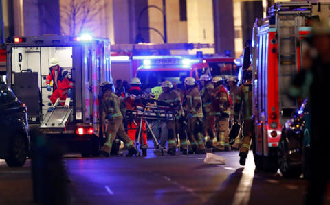 Police and emergency workers at the site of an accident at a Christmas market in the west of Berlin in December 2016 - Credit: REUTERS/Fabrizio Bensch