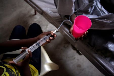 A patient is drip-fed in the Cholera Treatment Center of Diquini in Port-au-Prince, Haiti, September 7, 2016. REUTERS/Andres Martinez Casares