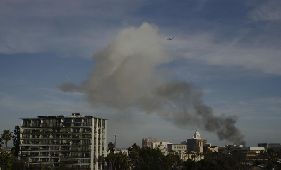 Smoke rises from an explosion at a structure fire Saturday, May 16, 2020, in Los Angeles. (AP Photo/Damian Dovarganes)