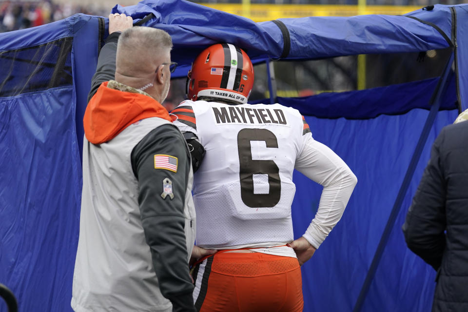 Cleveland Browns quarterback Baker Mayfield (6) walks into the medical tent to be examined during the second half of an NFL football game against the New England Patriots, Sunday, Nov. 14, 2021, in Foxborough, Mass. (AP Photo/Steven Senne)