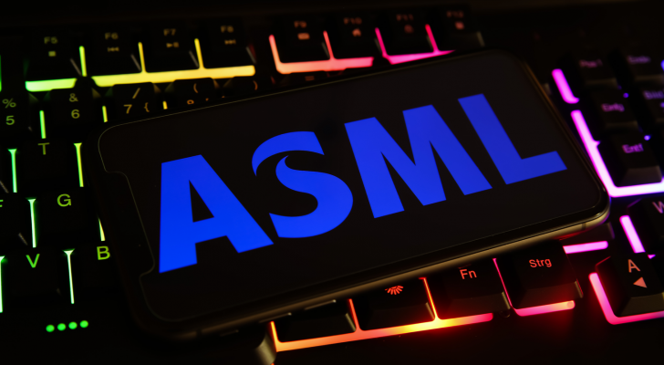 Closeup of mobile phone screen with ASML logo on computer keyboard